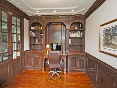 Stately office with custom moldings and work stati