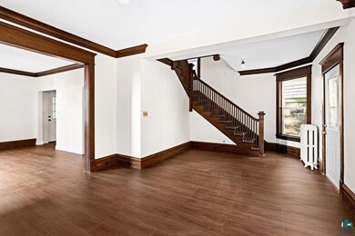Empty room with crown molding, dark hardwood / woo