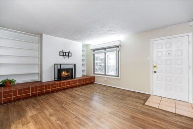 Unfurnished living room with wood finished floors