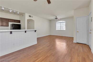 Unfurnished living room featuring a ceiling fan, b