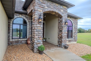 Beautiful stacked engineered stone covered entrance with arched windows