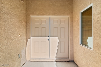 Property entrance with stucco siding