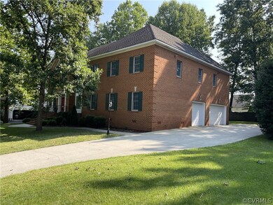 View of property exterior with a garage and a yard
