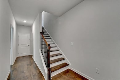 Stairs featuring wood finished floors, baseboards, and recessed lighting