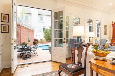Throw open the doors to the exquisite patio and saltwater pool.