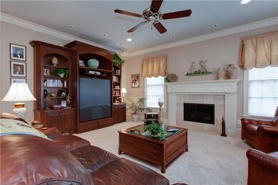 The den is a comfortable place with a gas fireplace and more wonderful views of the golf course.
