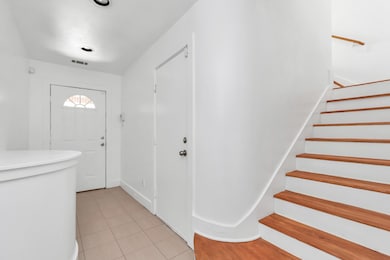 Front door entry way, garage door located to the r