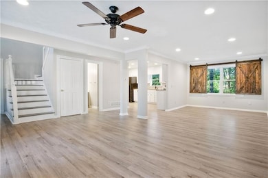 Unfurnished living room featuring a barn door, cro
