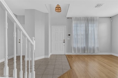 Entrance foyer featuring stairway and wood finishe
