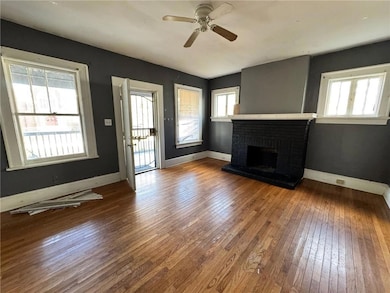 Unfurnished living room featuring a fireplace, har