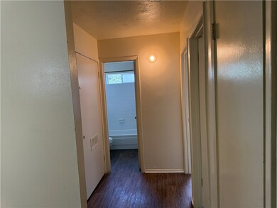 Hall featuring wood finished floors and baseboards