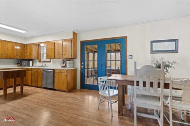 Kitchen with light wood finished floors, brown cab