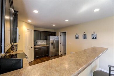 View of kitchen with pantry door and open door to 