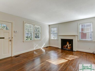 Large, airy living room with hardwood floors and c