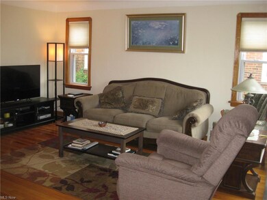 Living room w/ beautiful hardwood floors and custo