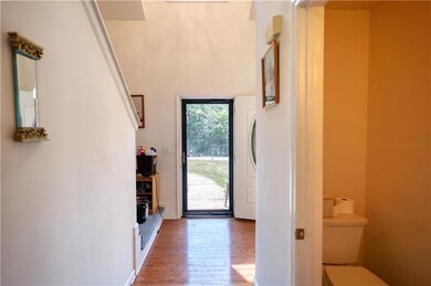 Foyer entrance featuring wood-type flooring and baseboards