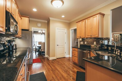 Spacious kitchen complete with granite, glass tile backsplash, stainless appliances, and pantry!