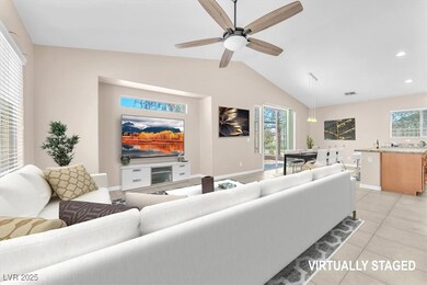 Living room with lofted ceiling, baseboards, light