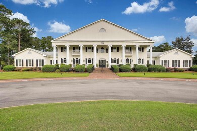 View of front facade with a front lawn, covered po