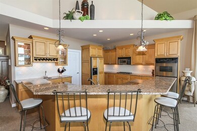 THE KITCHEN FEATURES A LARGE BREAKFAST BAR