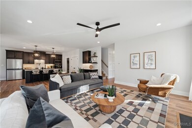 Living room with ceiling fan, light wood-style flooring, recessed lighting, stairway, and baseboards
