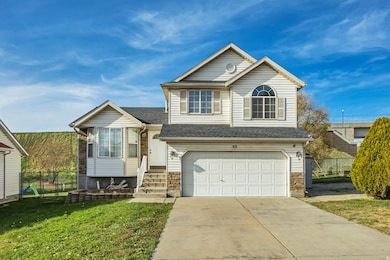 Traditional-style home with driveway, a garage, roof with shingles, and a gate