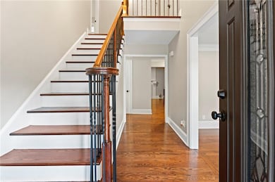 Foyer entrance with stairway, wood finished floors
