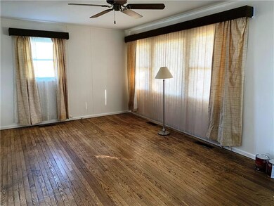 Living room is 18'x12'.  Hardwood floors just need