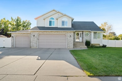 Traditional-style house featuring concrete driveway, brick siding, a garage, and a shingled roof
