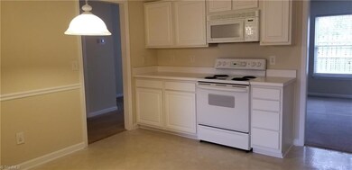 The kitchen includes all appliances (self cleaning stove, microwave, dishwasher, disposal, and refrigerator), an eating area, pantry, and chair rail moldings. There is plenty of cabinet space available.