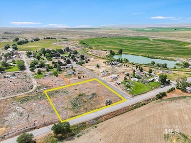 Aerial view of property and surrounding area with a nearby body of water and property boundaries highlighted