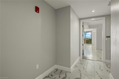 Welcoming foyer with marble-finish floors and soft natural light.