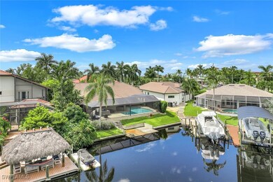 Dock area with a lanai, a lawn, and a water view