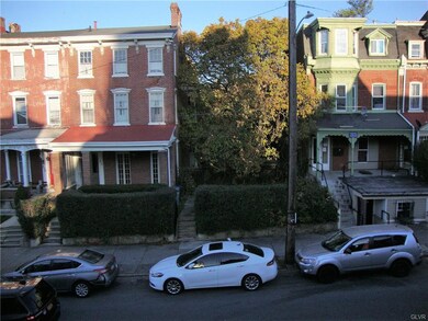 Double lot includes unit with red porch roof and l
