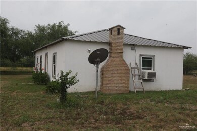 View of side of property featuring a yard