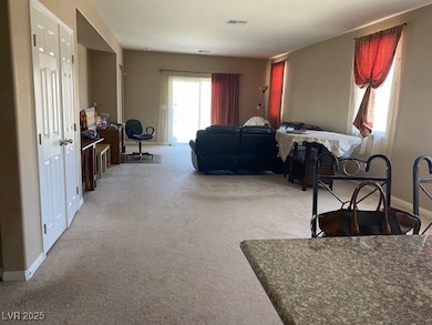 Carpeted living room with baseboards