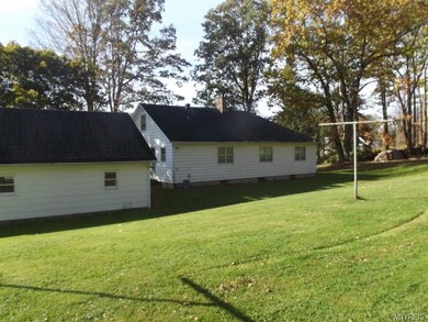Back of house and garage . lovely serene yard