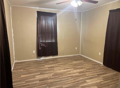 Spare room with a ceiling fan and wood finished f