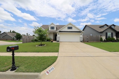View of front facade with driveway, an attached garage, board and batten siding, and brick siding