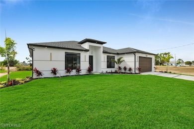 Prairie-style home with a garage, driveway, roof w