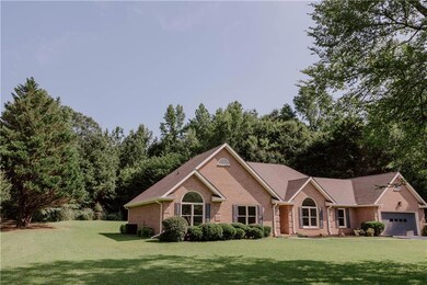 Ranch-style house with brick siding, a front yard, and an attached garage