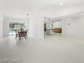 Kitchen featuring decorative light fixtures, appli