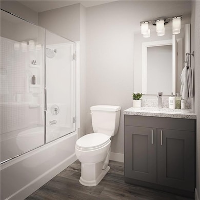 Full bath featuring vanity, toilet, baseboards, bath / shower combo with glass door, and wood finished floors