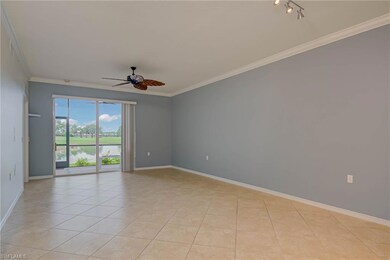 Spare room with a ceiling fan, ornamental molding, light tile patterned floors, and a water view