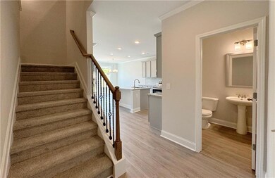Stairs featuring baseboards, ornamental molding, w