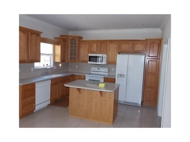 Kitchen. Kitchen with center island and all appliances remain.