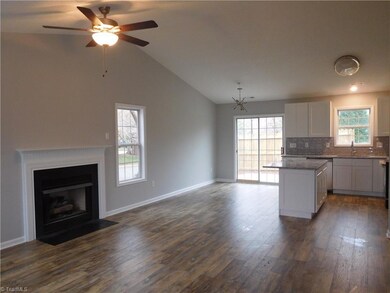 Living room w/fireplace and vaulted ceilings.  All New Flooring throughout home.