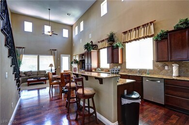 Kitchen featuring dishwasher, dark wood-style floo