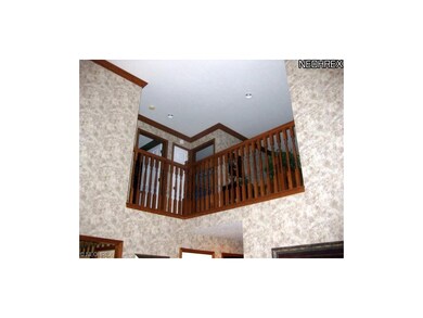 The second-floor hallway overlooks the great room.
