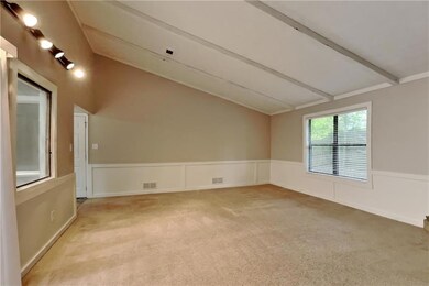 Spare room with wainscoting and light colored carpet